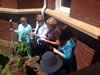 Members plant a dogwood tree at historic Independence, Virginia, courthouse in honor of Virginia DAR State Regent Virginia Storage.